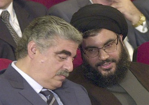 May 25, 2001 Former Lebanese Prime Minister Rafik Hariri, left, talks with Hezbollah leader Sheik Hassan Nasrallah, right, during an official ceremony to mark the first anniversary of the Israeli withdrawal from south Lebanon, in Beirut, Lebanon. Credit: Mahmoud Tawil