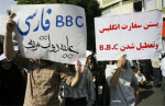 Pro-Ahmadinejad supporters hold up anti-BBC slogans in Tehran (AFP)