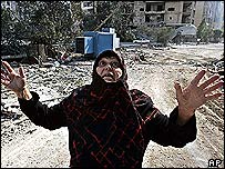 A Lebanese woman reacts at the destruction after she came to inspect her house in the suburbs of Beirut, Lebanon,