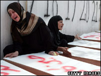 Women grieve over coffins at mass funeral in Tyre, Lebanon