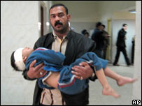 Man with child in Baghdad hospital