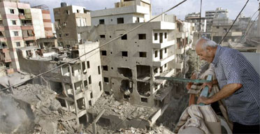 A man in a southern suburb of Beirut inspects damage caused by an overnight Israeli air raid. Photograph: Lefteris Pitarakis/AP.